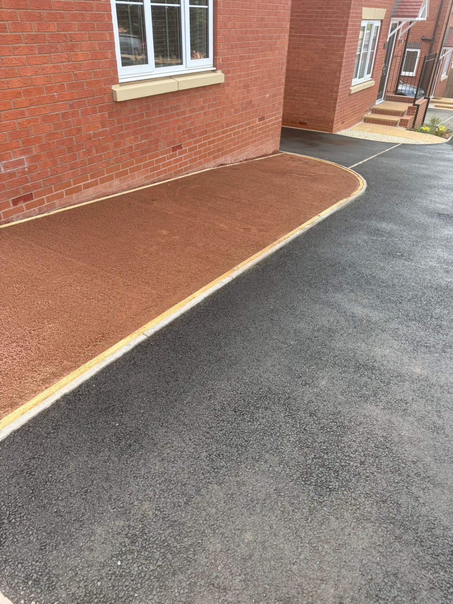 Curved red tarmac sub-base ready for resin-bound surfacing with block edging — Shrewsbury driveway prep